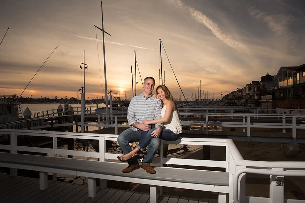 Shirley and Cris sitting together at the marina at sunset